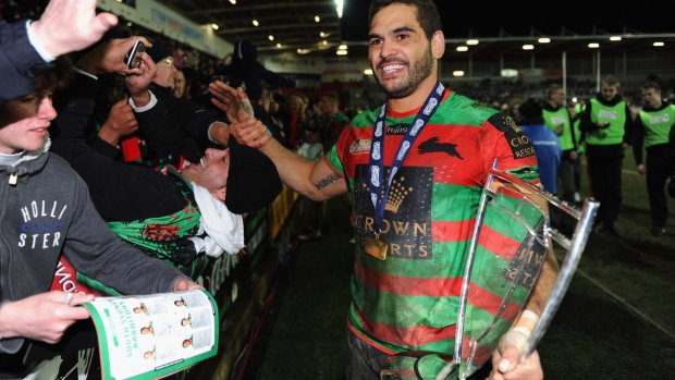 Champion again: Greg Inglis holds the World Club Challenge trophy in St Helens.