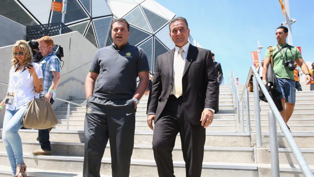 Australian Socceroos Coach Ange Postecoglou and Victorian Minister for Tourism and Major Events, John Eren are seen as they leave the stadium.