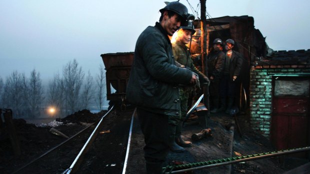Coal is unloaded after being mined in the Gaosan County No 2 Mine near the city of Datong in northern China. 