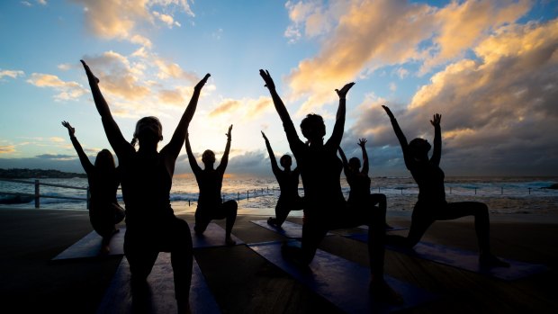 Stretching themselves: Corporate women who have become yoga teachers take a class at Wylie's Baths in Coogee.