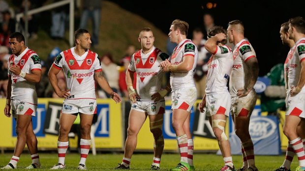Thrashed: Dragons players look dejected after conceding a try in the round 17 NRL match between the Manly Sea Eagles and St George Illawarra at Brookvale Oval.