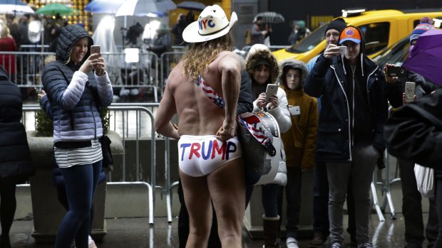 The near-naked cowboy performs in front of Trump Tower in New York on Monday