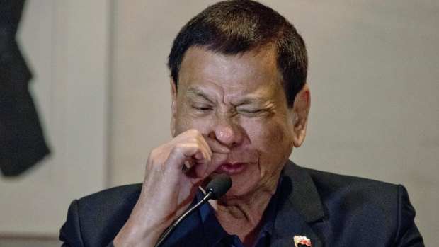 Philippines President Rodrigo Duterte imitates a drug addict at a press conference in Beijing.