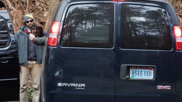 A man driving a van with diplomatic licence plates drives out of the Russian estate in Upper Brookville, Oyster Bay, on December 30.