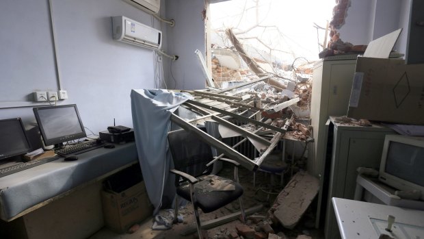 Rubble and debris spills into a room at the No.4 Hospital of Zhengzhou University after a demolition crew destroyed part of the facility.