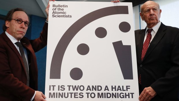 Lawrence Krauss, chair of the Bulletin of the Atomic Scientists Board of Sponsors, left, and Thomas Pickering, co-chair of the International Crisis Group, display the Doomsday Clock in Washington.