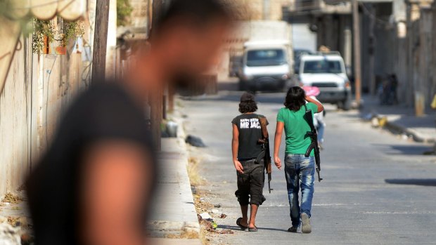 Young fighters of the Free Syrian Army walk the streets of Jarablus.