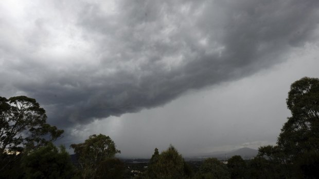 An afternoon storm rolls into Canberra, seen from Red Hill lookout. 