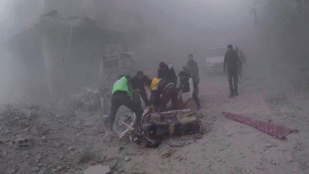 White Helmets carry an injured man after government air strikes hit Douma, near Damascus, Syria, on Sunday.