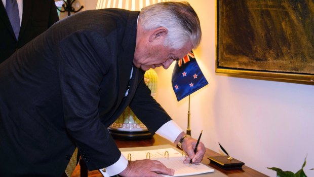 Rex Tillerson signs the visitor book at Premier House in Wellington on Tuesday