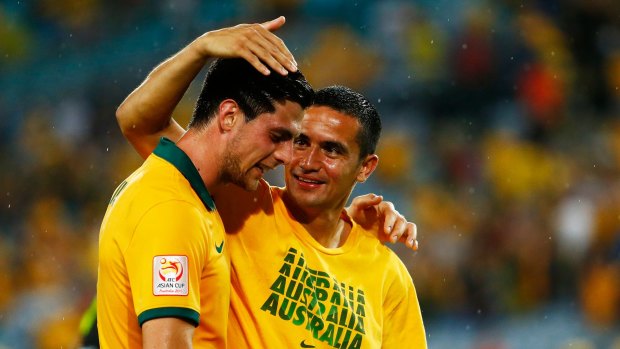 Biding his time: Tomi Juric with Tim Cahill.