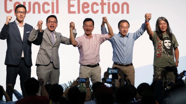 Pro-democracy candidates, from left, Lam Cheuk-ting, Alvin Yeung, Raymond Chan, Fernando Cheung and Leung Kwok-hung celebrate after winning seats at the legislative council elections.