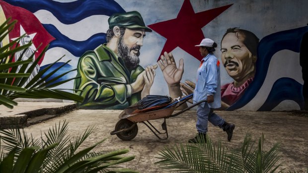 A worker passes a mural of Nicaraguan President Daniel Ortega in Managua last year. 