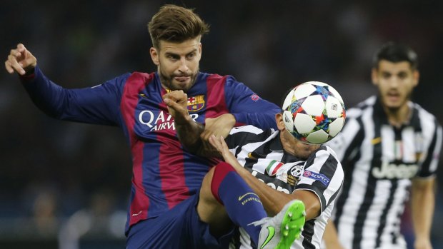 The show: Barcelona's Gerard Pique, left, challenges Juventus' Carlos Tevez for the ball.