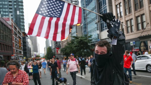 A protester burns an American flag in Seattle on Sunday.