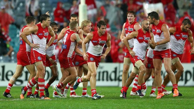 Isaac Heeney of the Swans celebrates with teammates after kicking a goal against Essendon on Saturday.