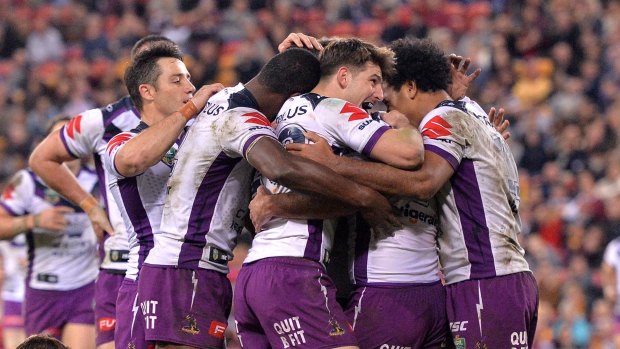 All smiles: Cam Smith is mobbed by teammates after scoring.