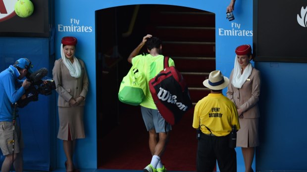 The vanquished: Holding his head, Roger Federer makes his way off the court.