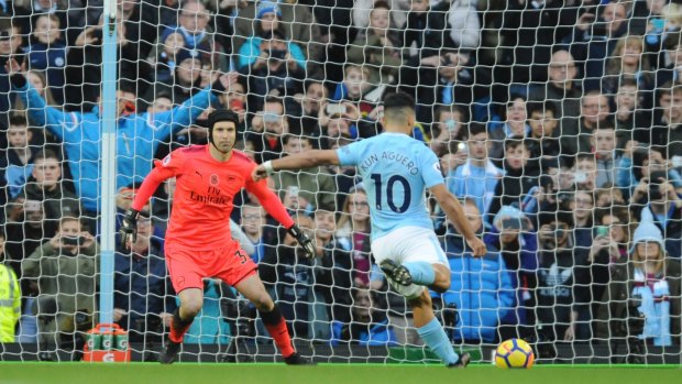 City's Sergio Aguero hits home from the penalty spot against Arsenal at Etihad stadium.