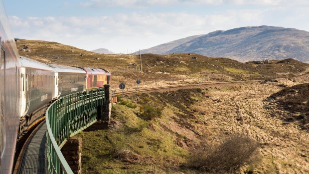 The Caledonian Sleeper train crosses Rannoch Viaduct in the Scottish Highlands.