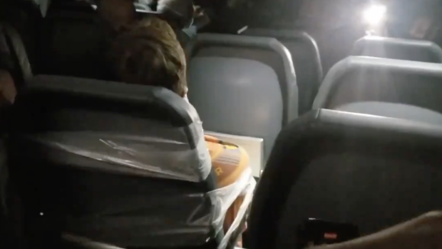 Flight attendants taped the unruly passenger to a seat and tied him with a seatbelt extender.