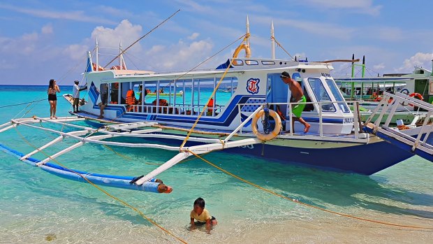 One of the bangkas - traditional Filipino fishing boats - bringing tourists to Puka Beach, Boracay.