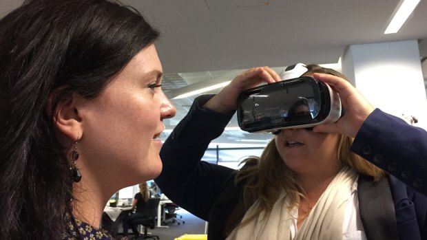 Hannah Francis helps crime reporter Rania Spooner adjust the Samsung Gear VR.