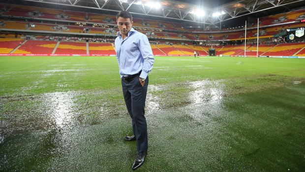 Washed out: Cooper Cronk inspects the field before the Test match on Friday.