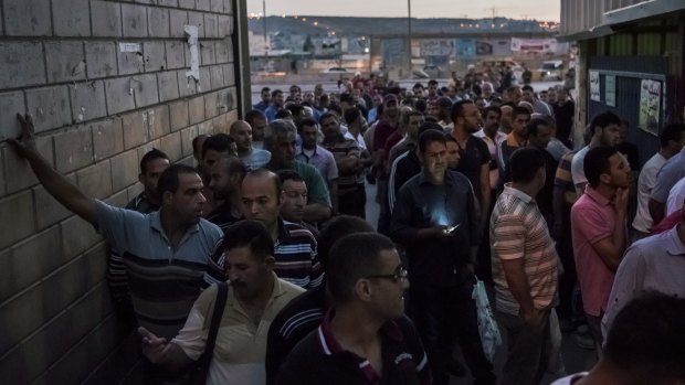 Labourers with work permits line up to pass through the Qalandiya checkpoint from the West Bank into Israel earlier this month. 