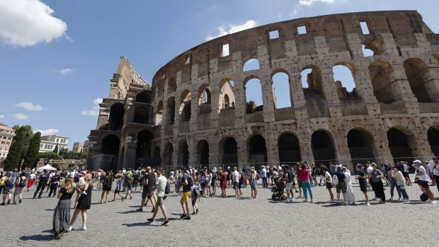 Tourists wait in a queue to enter the Colosseum in Rome using Italy's Green Pass.