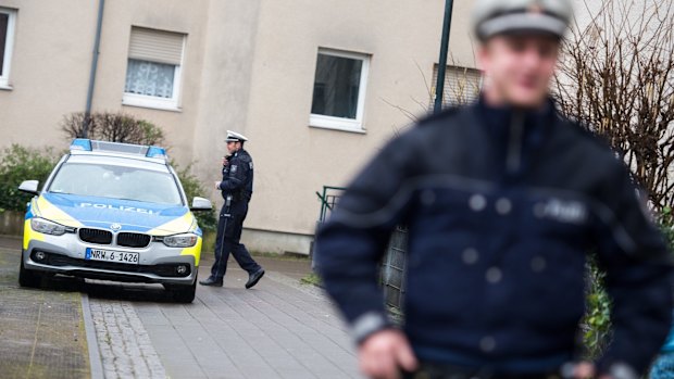 Police officers in front of a house in Duesseldorf, where a German magazine says two people with possible links to the Brussels attacks were arrested on Friday.