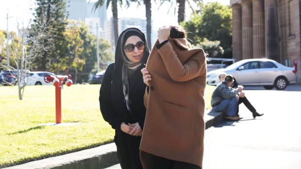 Mohammed Hamzy's wife, Meltem Yarar, (under the coat) and sister, leave the NSW Supreme Court.