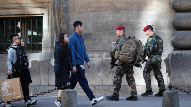 French soldiers patrol outside the Louvre museum near where a soldier opened fire after he was attacked in Paris, on February 3, 2017.