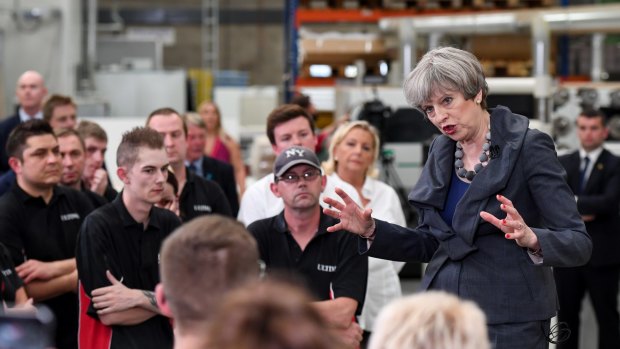British PM Theresa May speaks to workers during a campaign stop at Ultima Furniture Systems in Pontefract on Thursday.