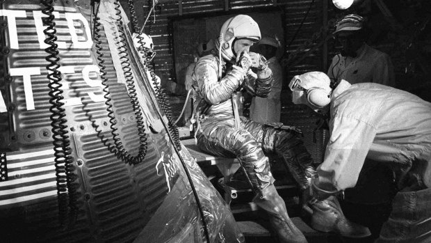 John Glenn sits next to the Friendship 7 space capsule atop an Atlas rocket at Cape Canaveral during flight in 1962