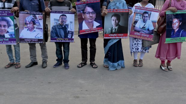 Bangladeshi social activists hold portraits of people killed in the last few years as a result of terrorism in     Bangladesh.