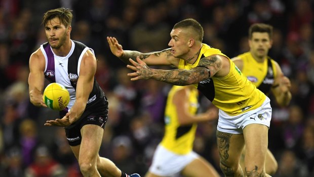 Heavy loss: Koby Stevens clears ahead of Richmond's Dustin Martin in the round 16 contest that sent the Tigers crashing back to earth.