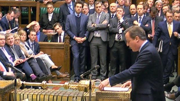 British Prime Minister David Cameron addresses Members of Parliament  in the House of Commons in London on Monday.