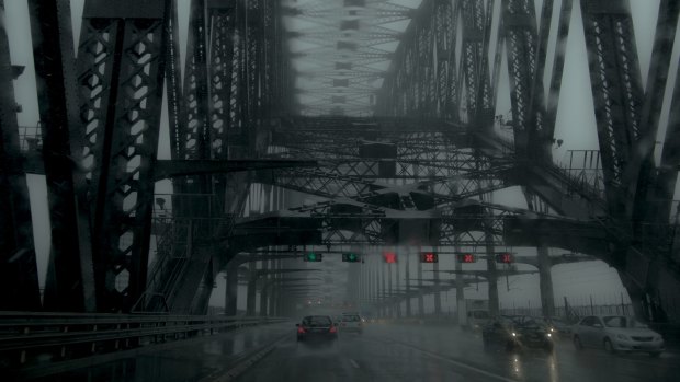 Heavy rain and grey skies descended on the Sydney Harbour Bridge on Tuesday morning.