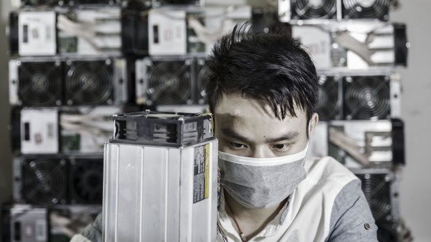 A technician makes repairs to bitcoin mining machines at a mining facilityin China.
