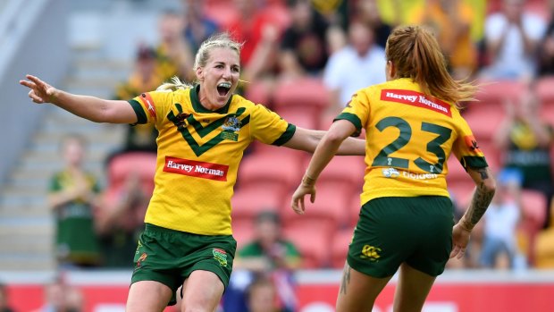Giant leap for women's rugby league: Ali Brigginshaw, left, and Caitlin Moran celebrate after winning the World Cup last week.