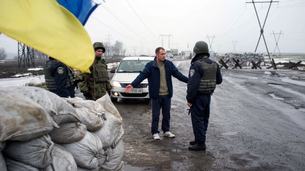 Ukrainian soldiers check passengers of a car at a checkpoint in the eastern Ukrainian city of Kurakhove, near Donetsk, as heavy fighting raged on Wednesday.