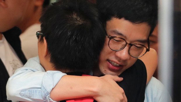 Nathan Law hugs a supporter before the ruling.