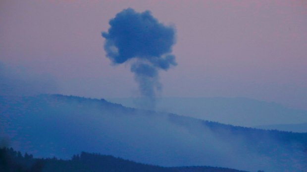 Plumes of smoke rise on the air from inside Syria, as seen from the outskirts of the border town of Kilis, Turkey.