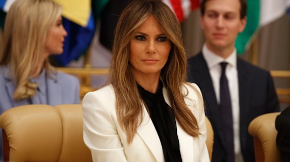 First Lady Melania Trump listens as her husband speaks.