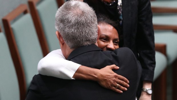 Liberal MP and committee chairman Ken Wyatt embraced by Labor senator and deputy chair Nova Peris after he tabled the committee's report on constitutional recognition of Aboriginal and Torres Strait Islander Peoples.