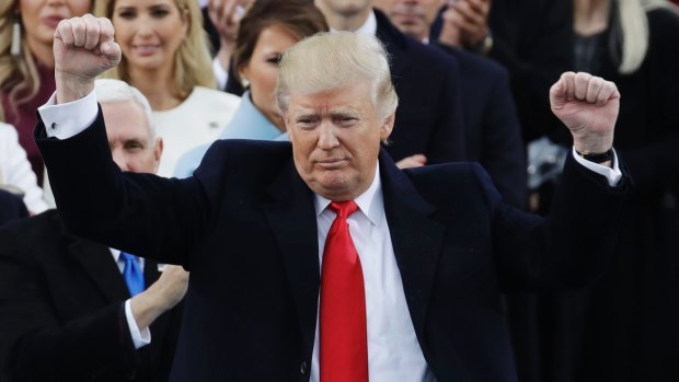 President Donald Trump pumps his fist after delivering his inaugural address.