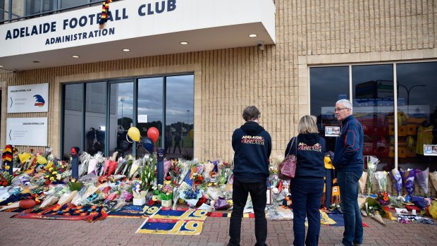 People pay tribute at Adelaide Crows headquarters on Saturday.