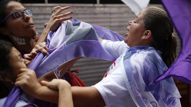 Anti-government demonstrators clash with a supporter of Dilma Rousseff on International Women's Day in Sao Paulo last week.