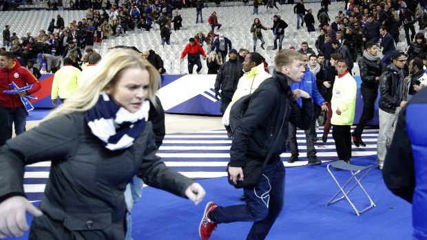 Spectators flee the Stade de France stadium after the international friendly soccer match between France and Germany.